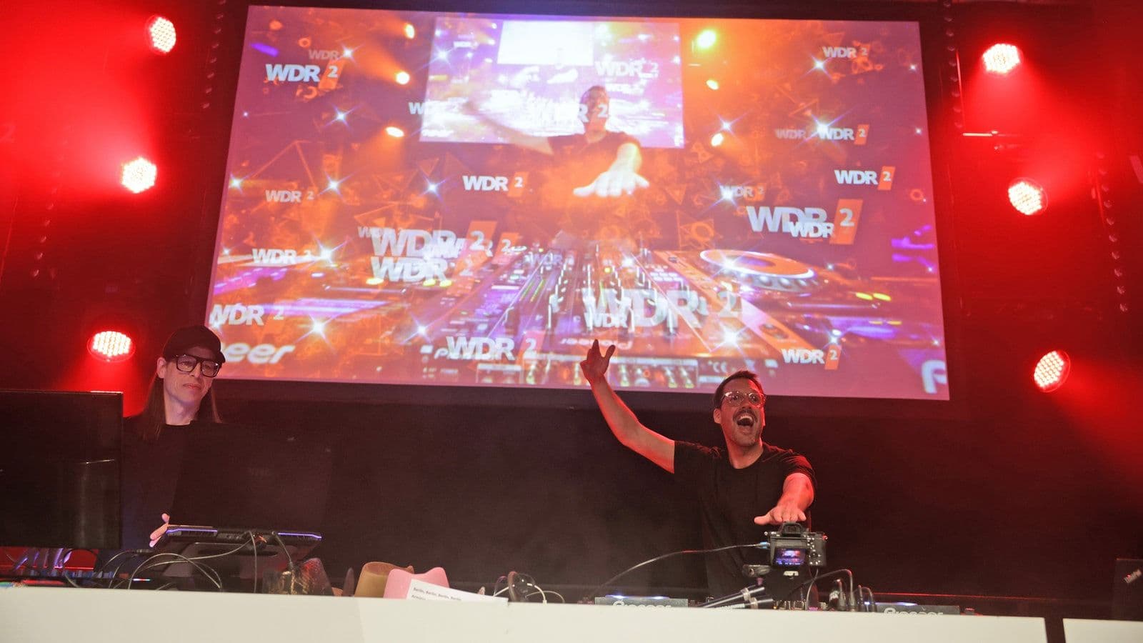 Ein DJ steht vor einer Leinwand auf der WDR 2-Hausparty. | Bildquelle: WDR mediagroup  Ein DJ steht vor einer Leinwand auf der WDR 2-Hausparty.
